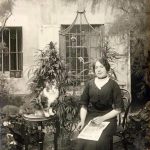 A Parisian woman in her cannabis garden, with her cat. 1910.
