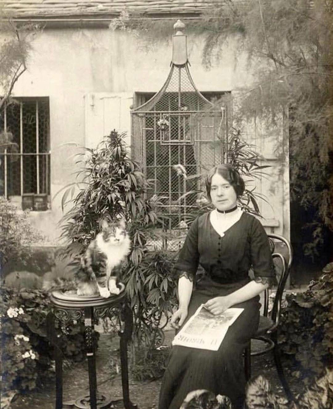 A Parisian woman in her cannabis garden, with her cat. 1910.