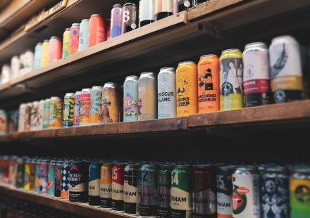 assorted plastic bottles on brown wooden shelf