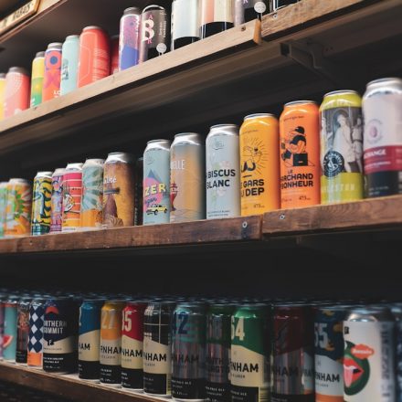 assorted plastic bottles on brown wooden shelf