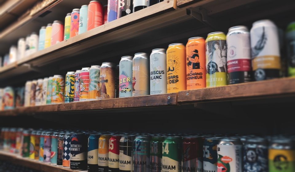 assorted plastic bottles on brown wooden shelf