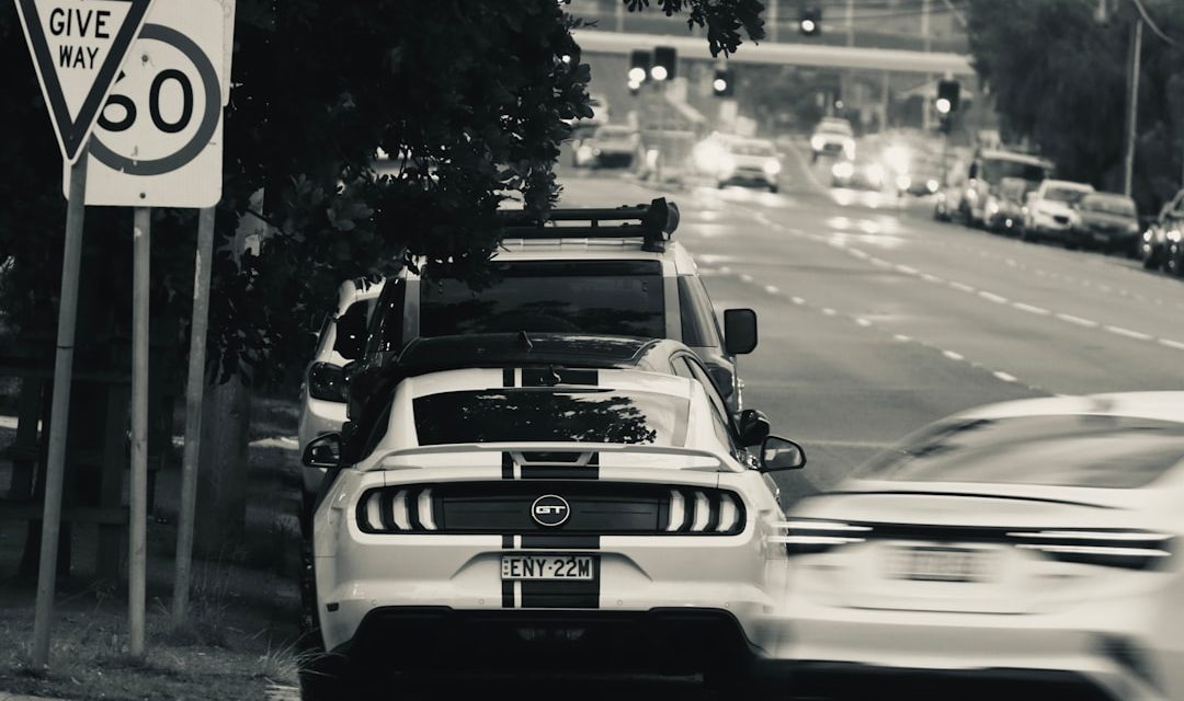 Traffic on an Australian urban road beside give way and speed limit signs