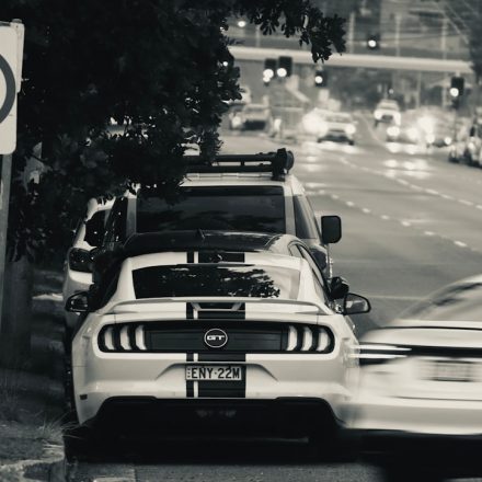 Traffic on an Australian urban road beside give way and speed limit signs