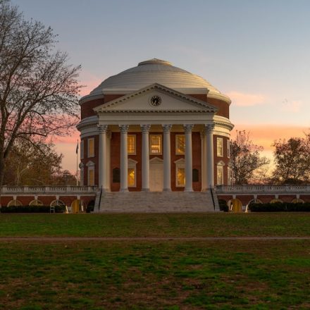 a building with a dome in the middle of a field