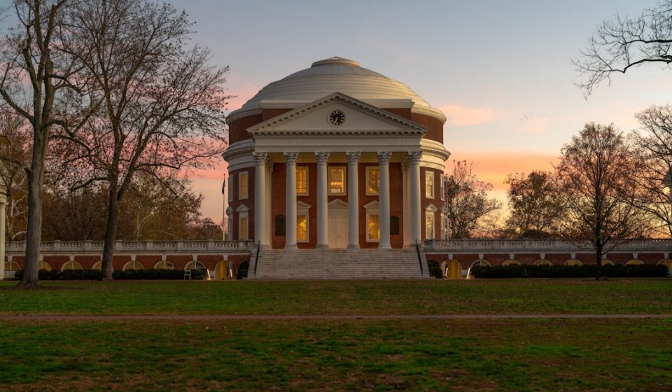 a building with a dome in the middle of a field